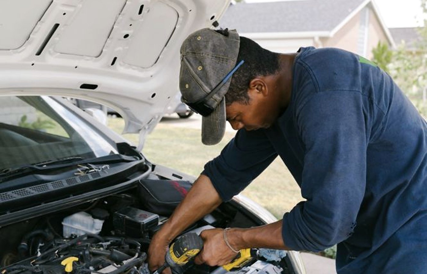 Grand Rapids mobile mechanic working under a hood at a home visit